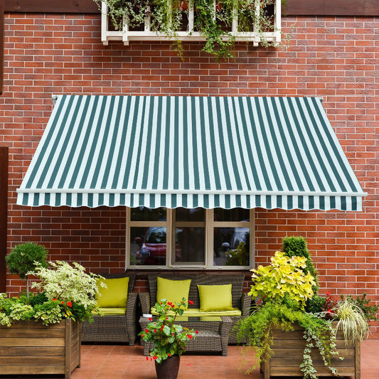 Green and white striped awning over a patio with chairs and plants on a brick wall background