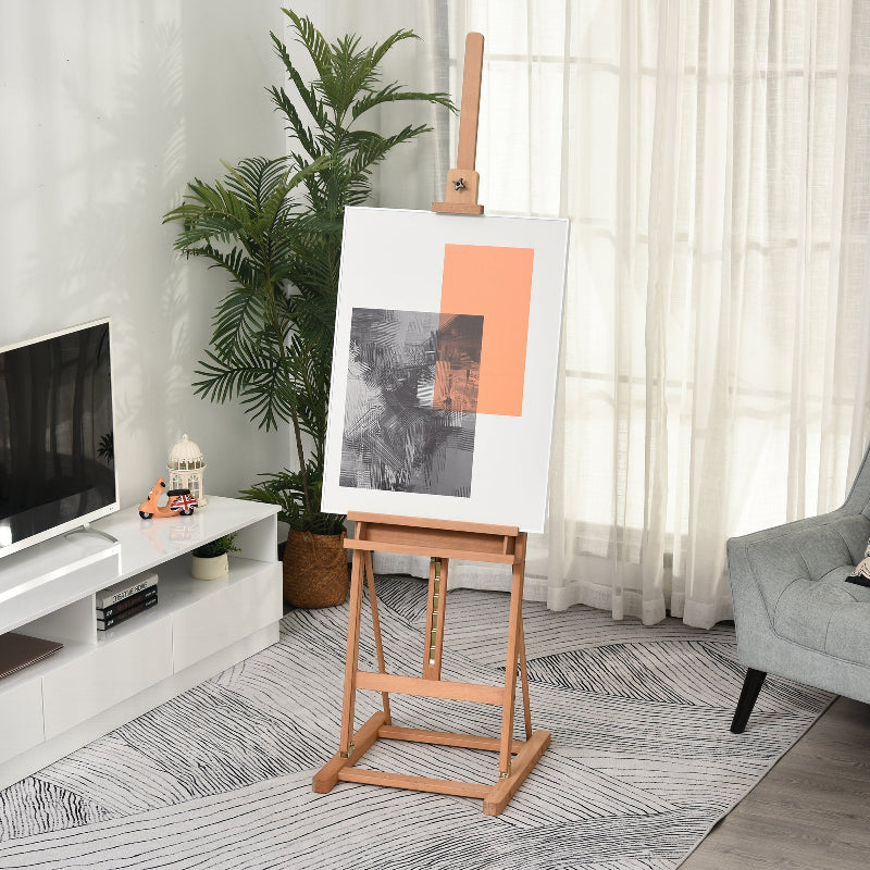 Room interior with a TV, plant, and easel displaying artwork.