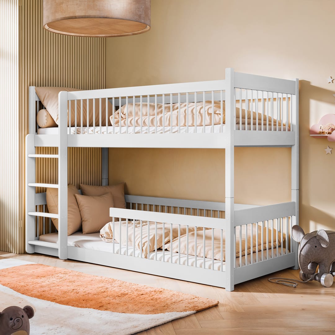 A white wooden bunk bed with a ladder, placed in a room with a light interior. The top bunk is equipped with a guardrail, and there are two beds in total.