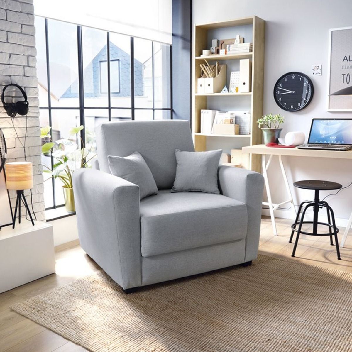 A single sofa bed with gray velvet upholstery and dark-stained wooden legs, positioned in a well-lit, modern living room setting.