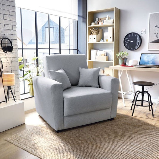 A single sofa bed with gray velvet upholstery and dark-stained wooden legs, positioned in a well-lit, modern living room setting.
