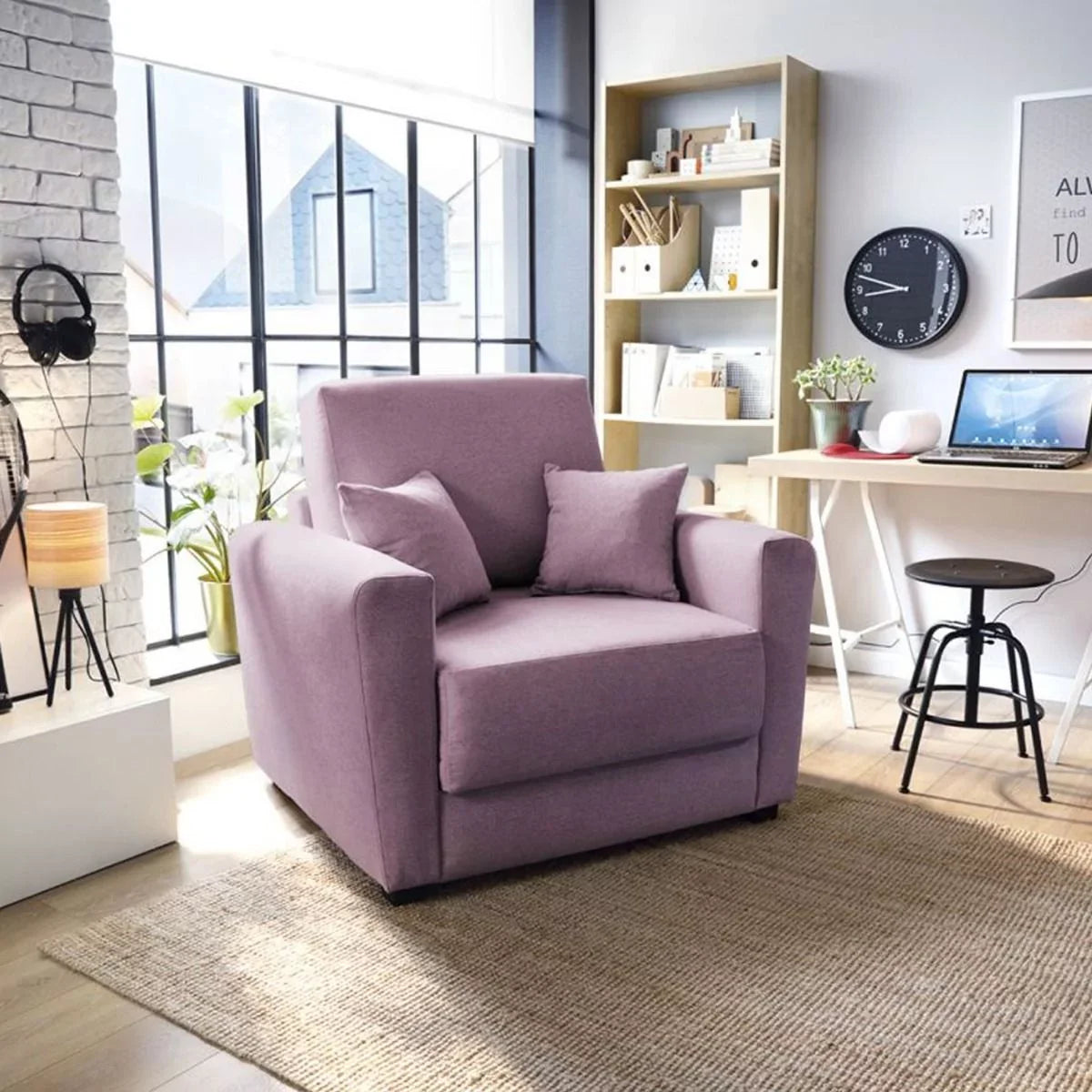 A pink velvet sofa bed with dark wooden legs, situated in a room with minimalistic decor, next to a window.