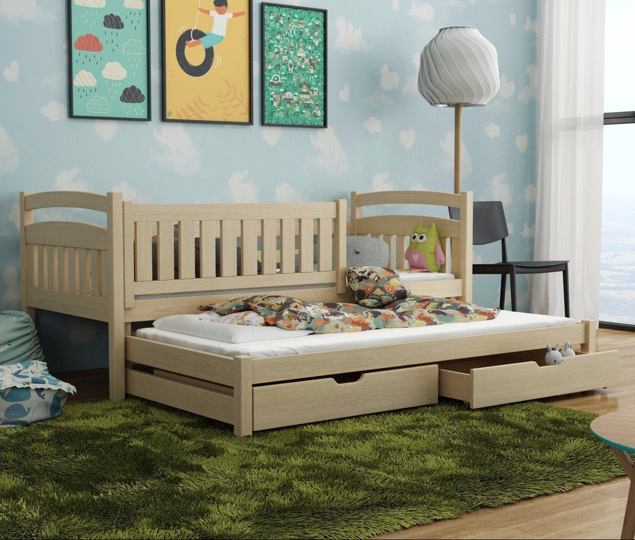 Wooden bed with pull-out drawer in a room with colorful wall art and a lamp.