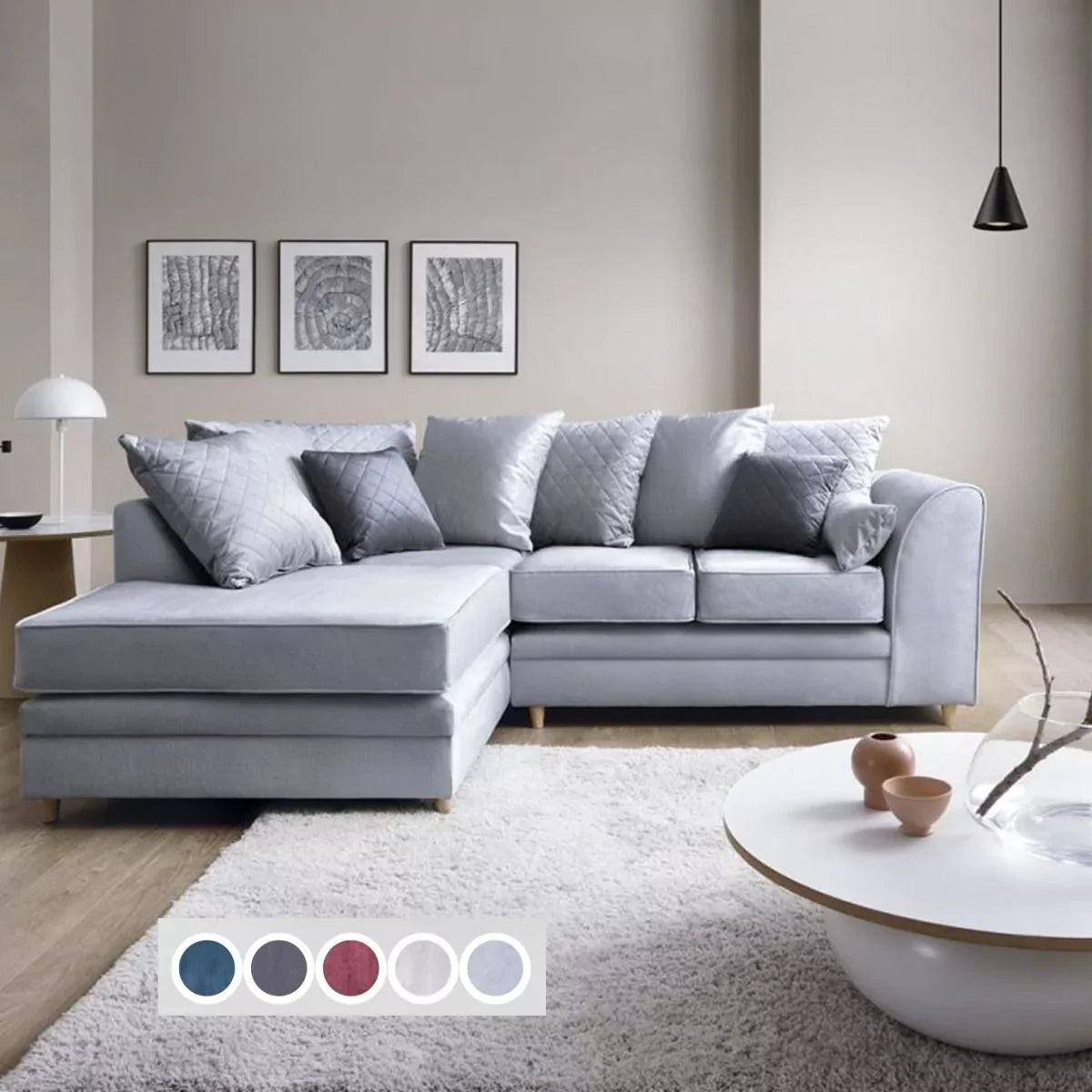 A silver blue velvet corner sofa with multiple cushions, placed in a room with a white rug and a coffee table, alongside a color palette indicating the available color options.