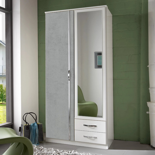 White wardrobe with mirror and drawers against a green wall